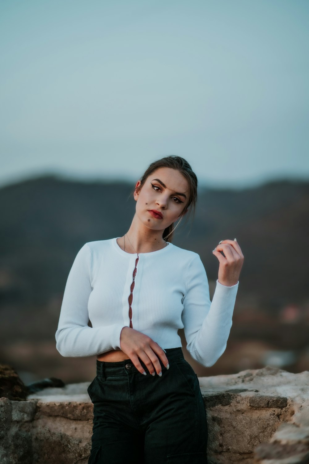 a woman in a white shirt and black pants