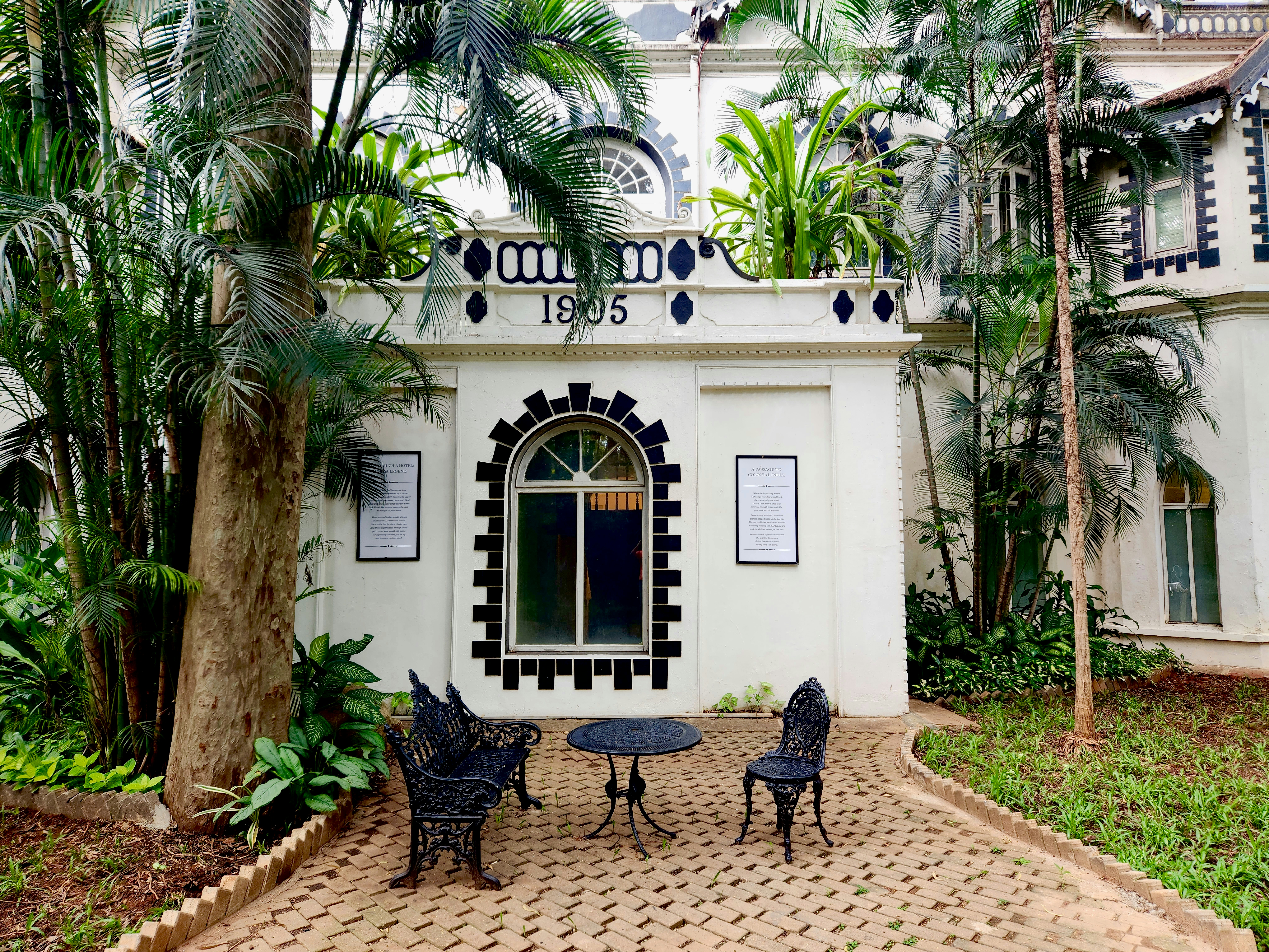 Pictured here is one of the buildings of the Taj West End that was originally established in 1887 by a British woman named Mrs. Bronson. At that time, it was known as the "Bangalore Club." It was primarily a boarding house for British army officers and civil servants stationed in Bangalore during the British colonial period. In 1984, the Tata Group, one of India's oldest and most respected conglomerates, acquired the Bangalore Club and transformed it into the Taj West End. This acquisition marked the entry of the Taj Hotels Resorts and Palaces group into Bangalore's hospitality sector.