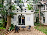 a patio with a table and chairs in front of a building