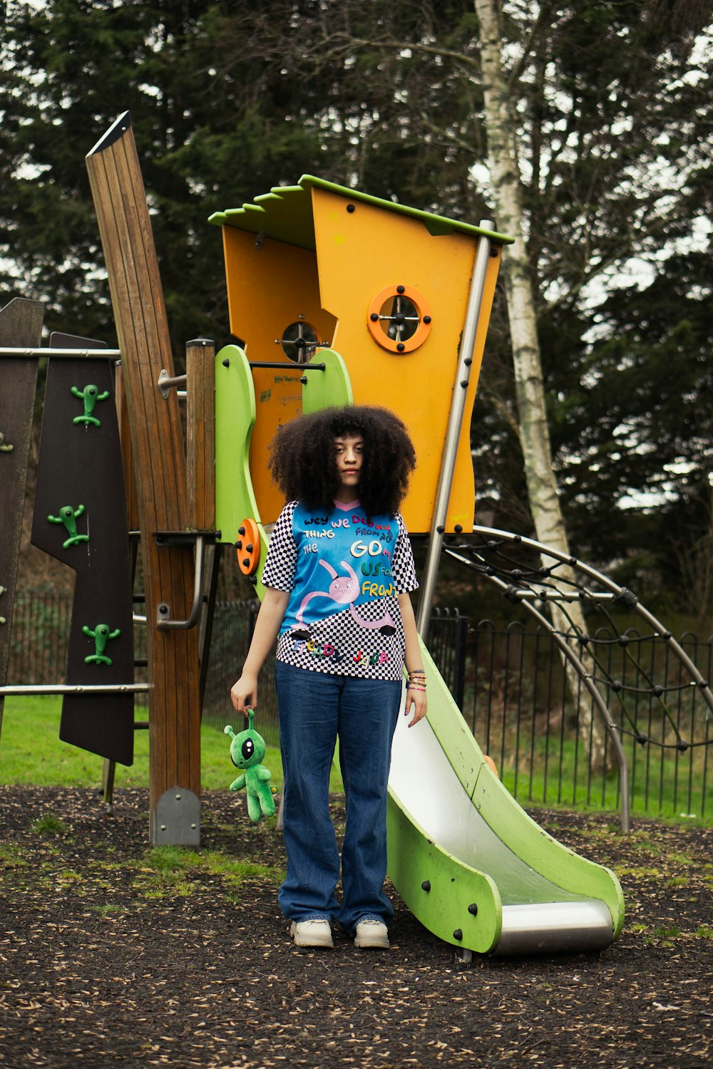 a woman standing in front of a playground