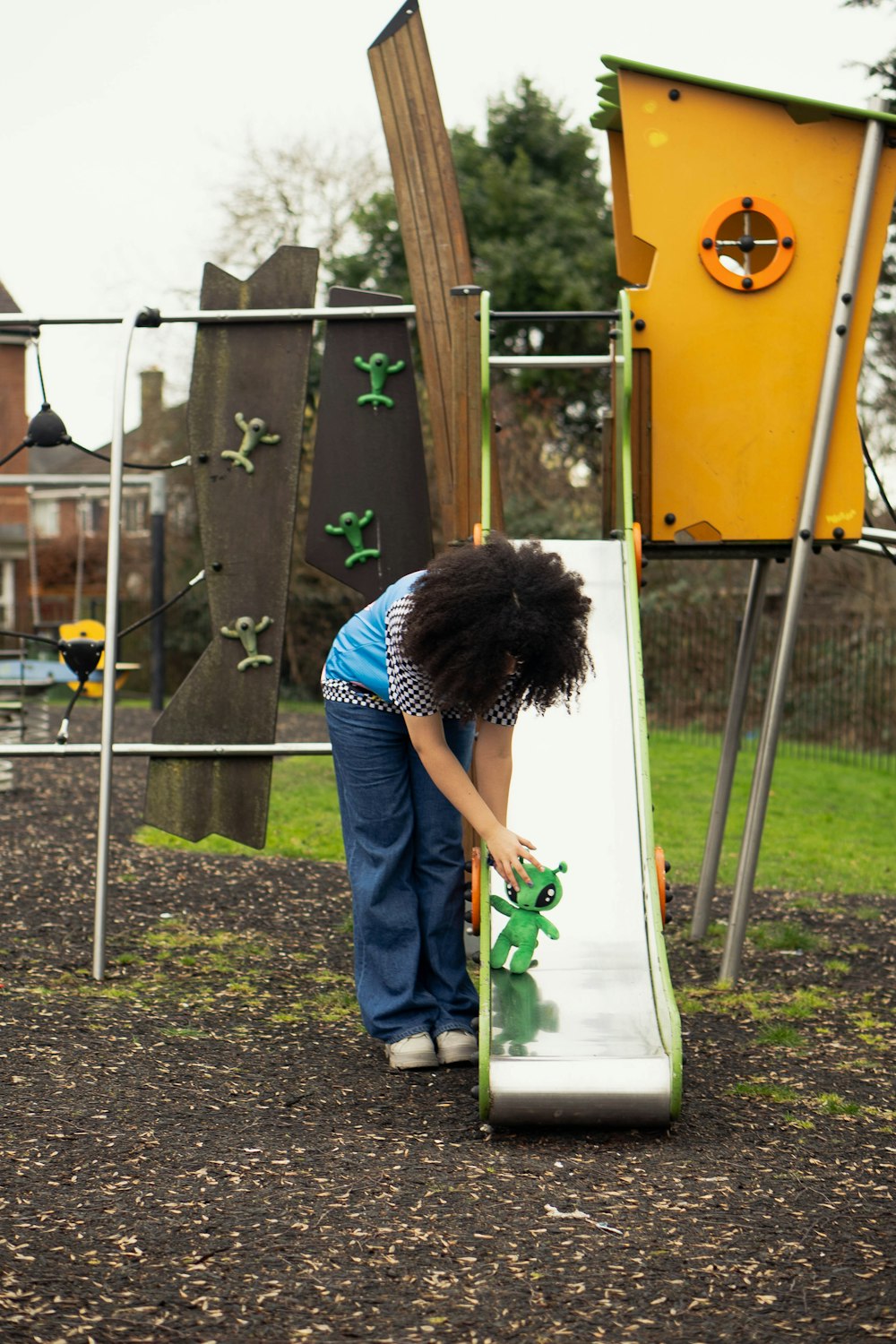 a young girl playing on a slide at a playground