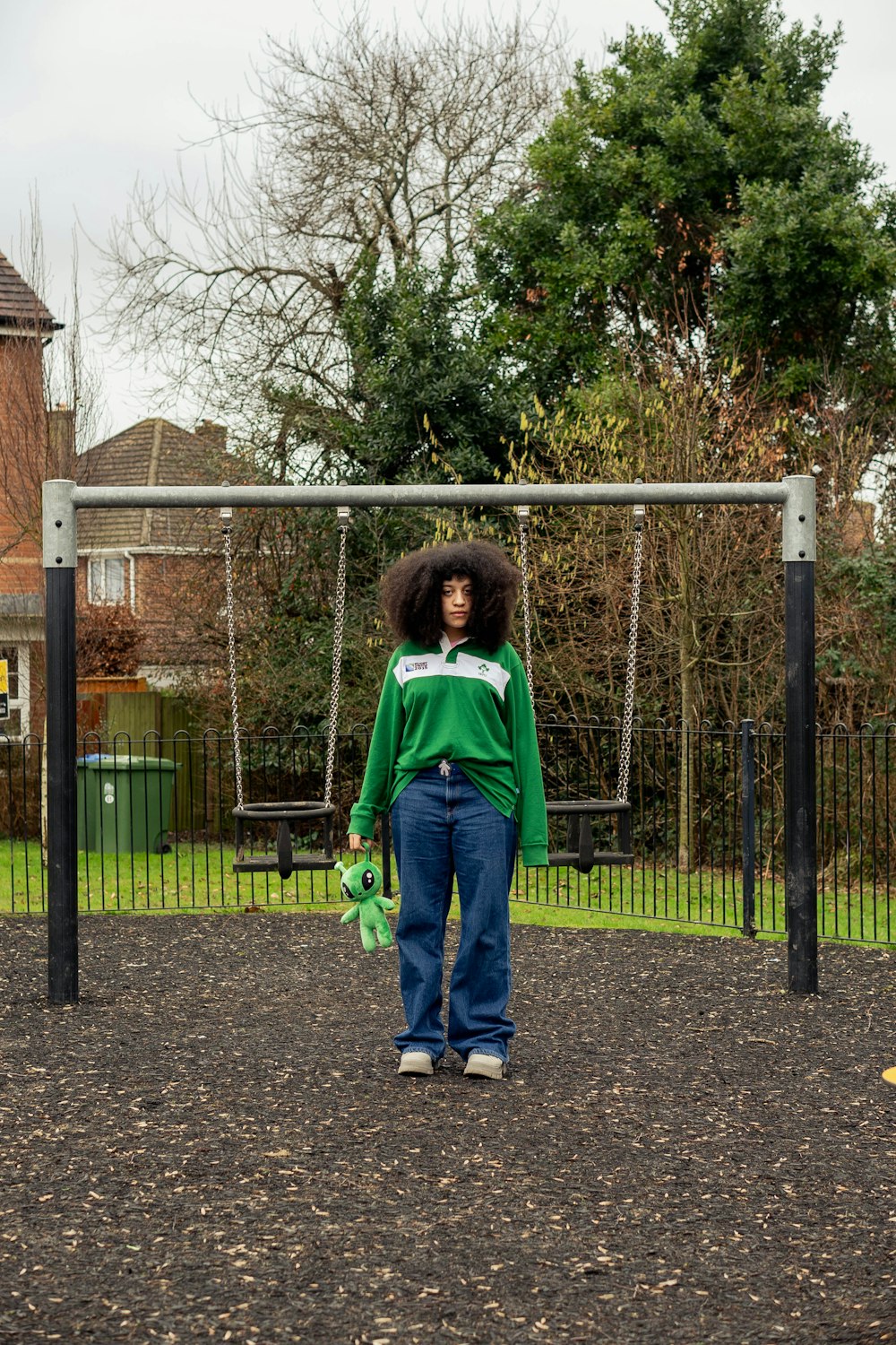 a woman standing in front of a soccer goal