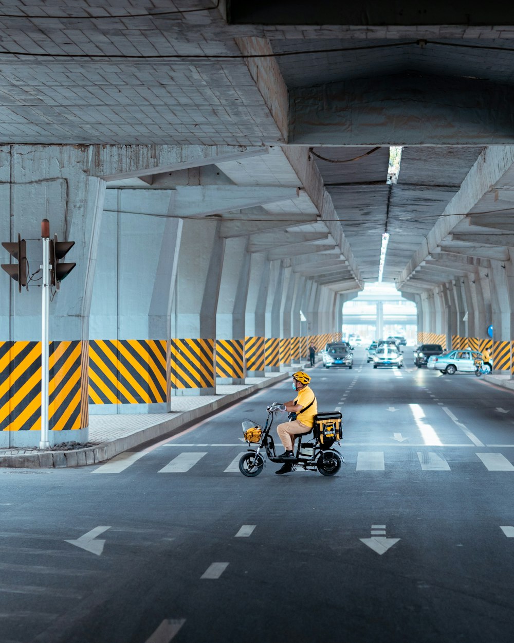 a person riding a scooter on a city street