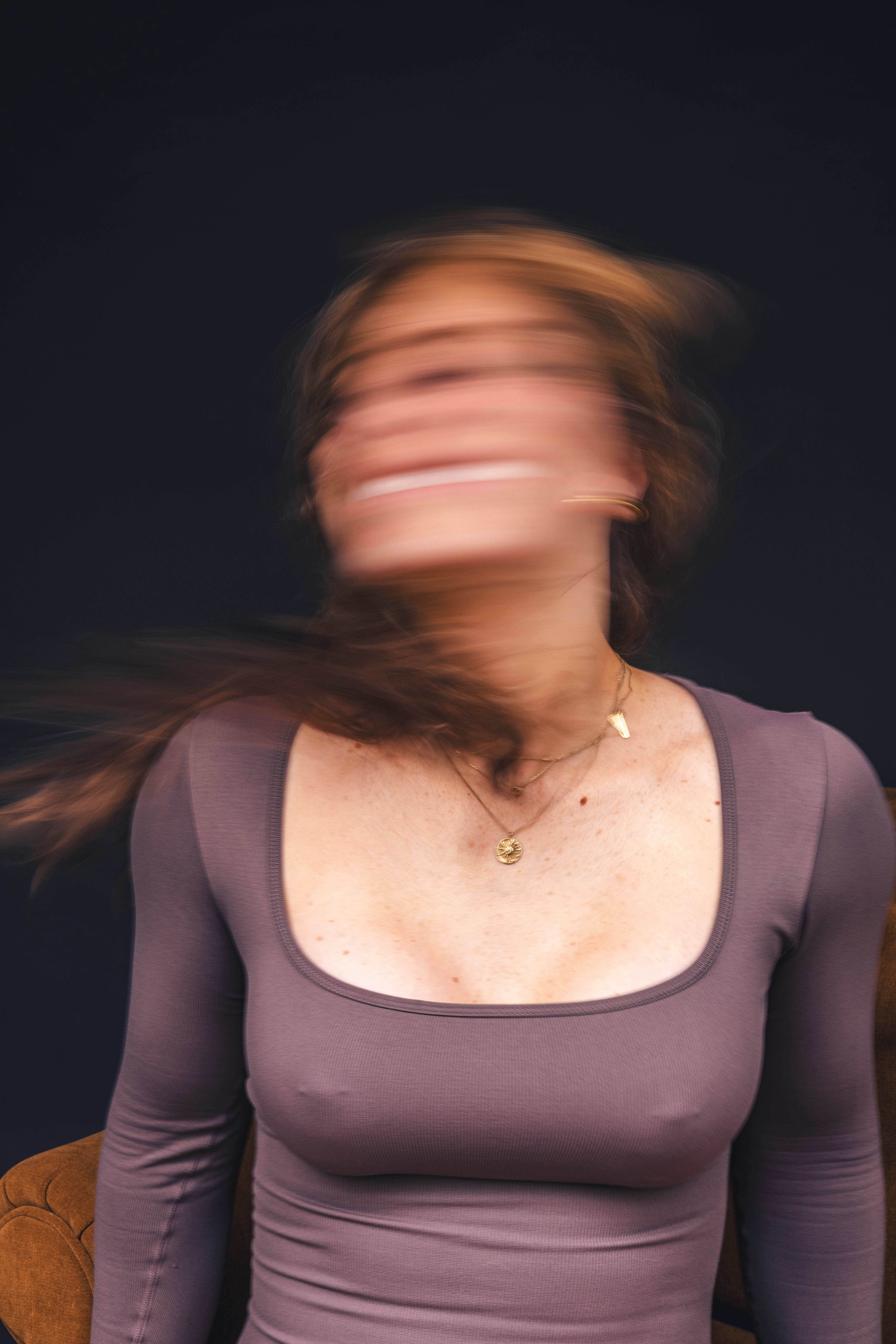 A person smiling while holding a moving box.