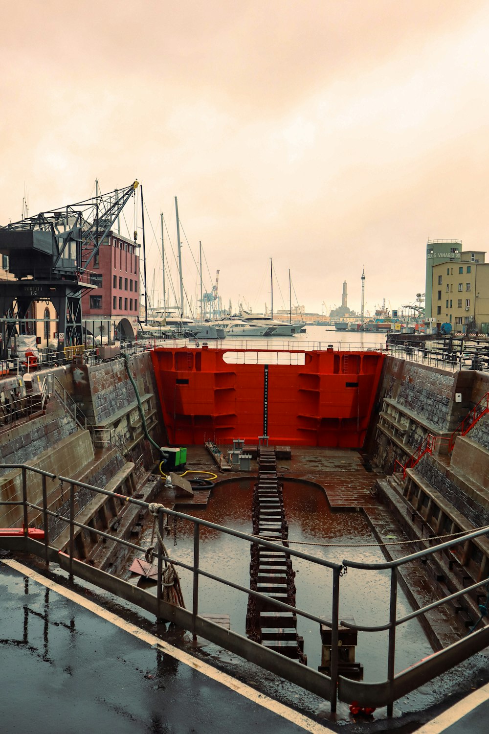 a boat dock with a red wall and stairs