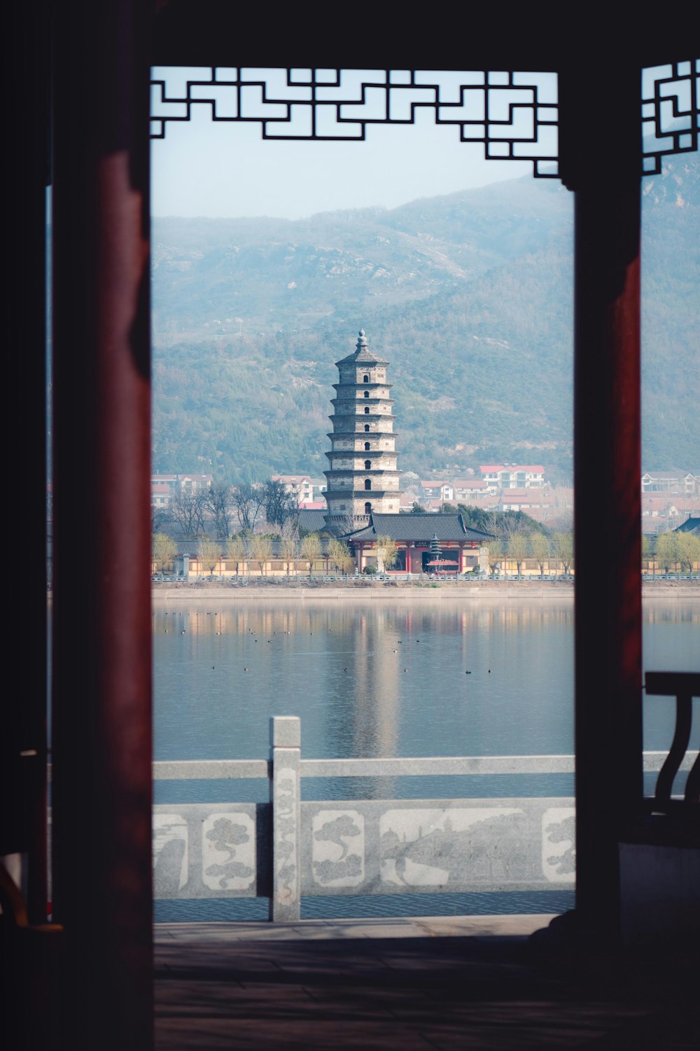 a view of a pagoda tower from across a lake