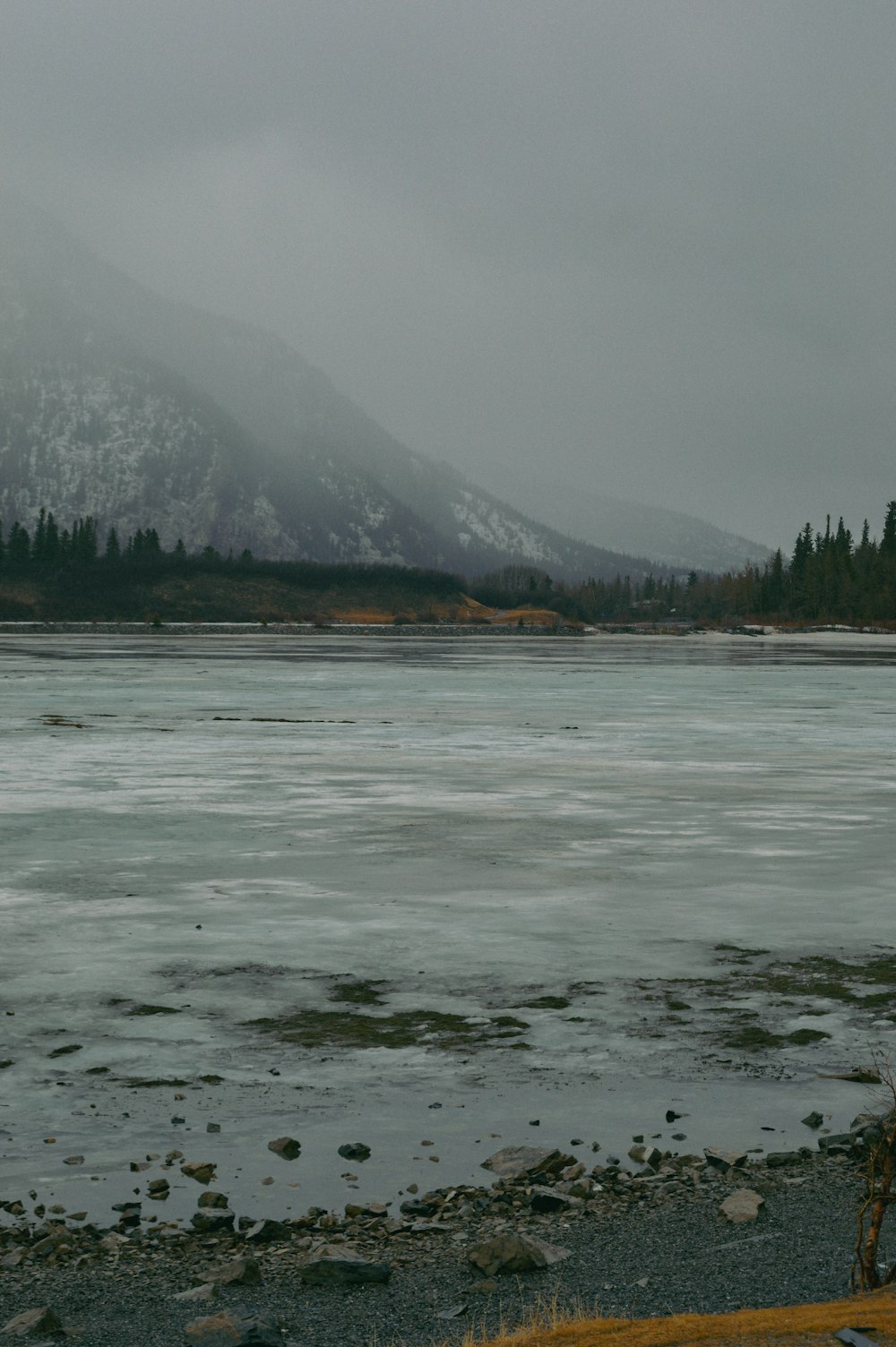 a large body of water with a mountain in the background