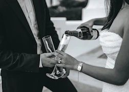 a couple of people that are holding wine glasses