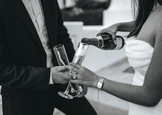 a couple of people that are holding wine glasses