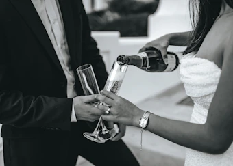 a couple of people that are holding wine glasses