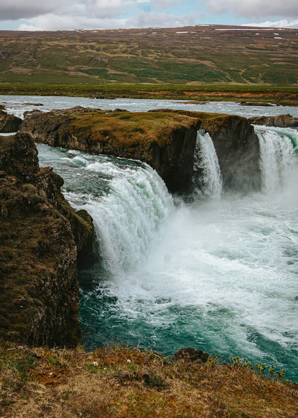 a river with a waterfall in the middle of it