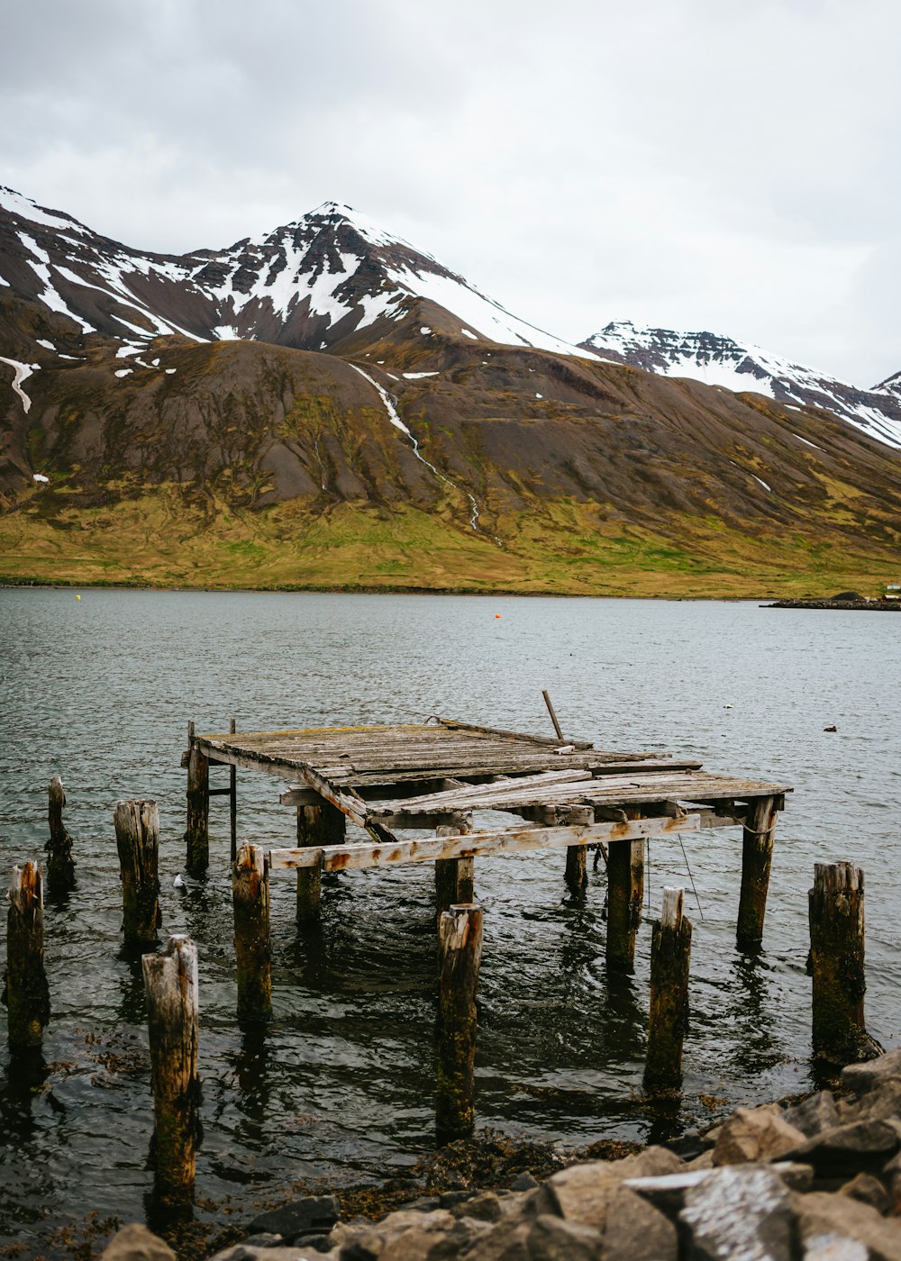 a wooden dock sitting in the middle of a lake