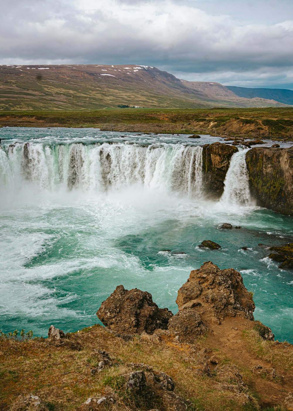 a view of a waterfall in the middle of a body of water