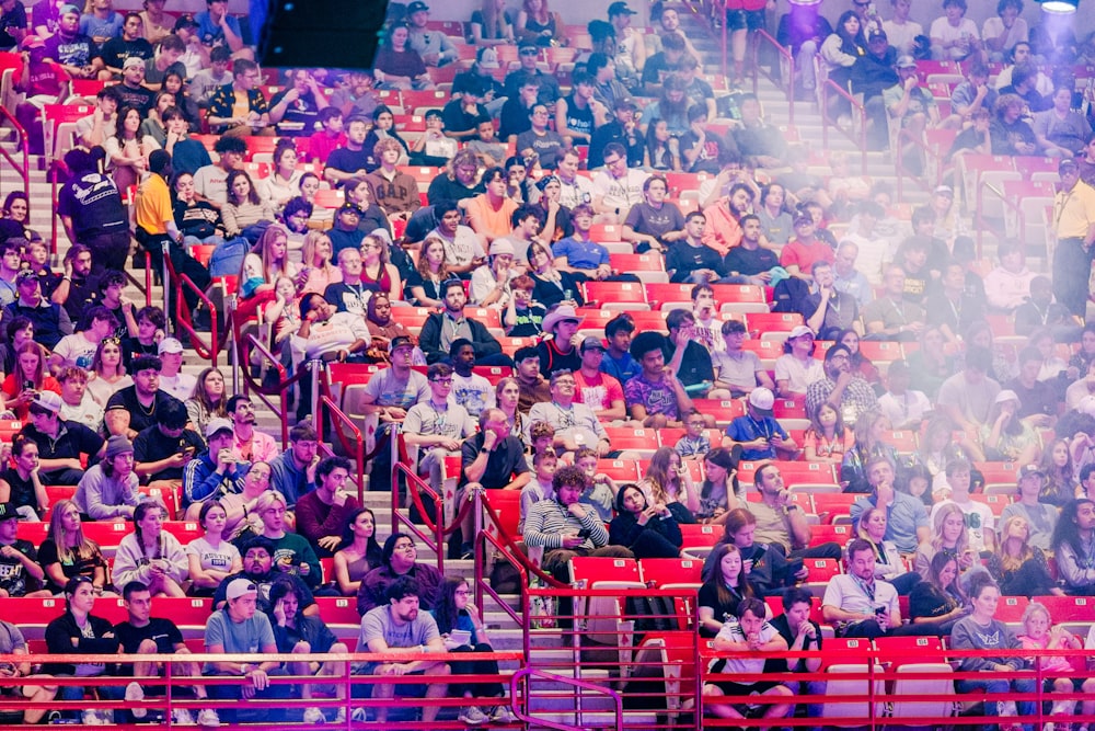 a large crowd of people sitting in a stadium