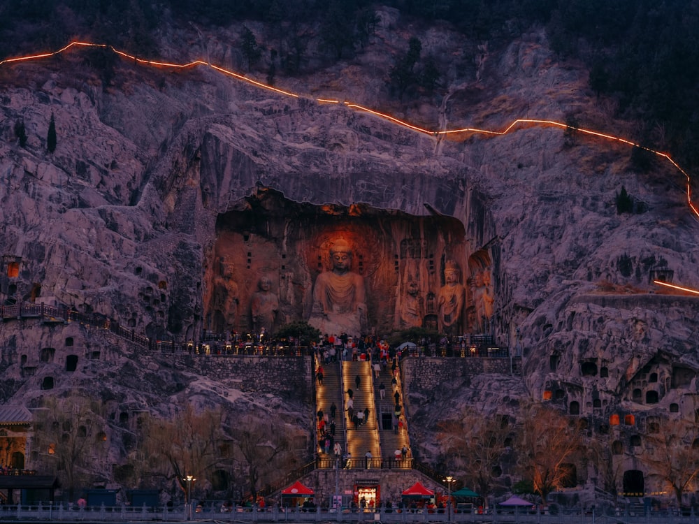 a large mountain with a statue on top of it