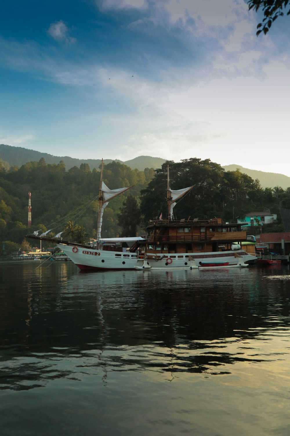 a large white boat floating on top of a lake