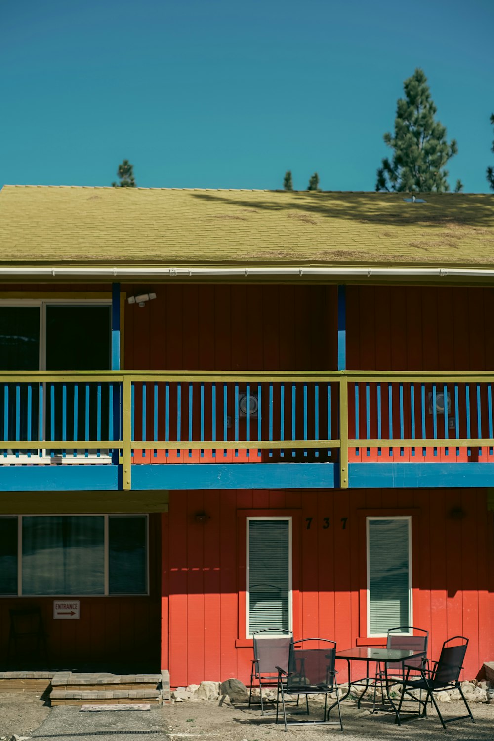 a red and blue building with a balcony