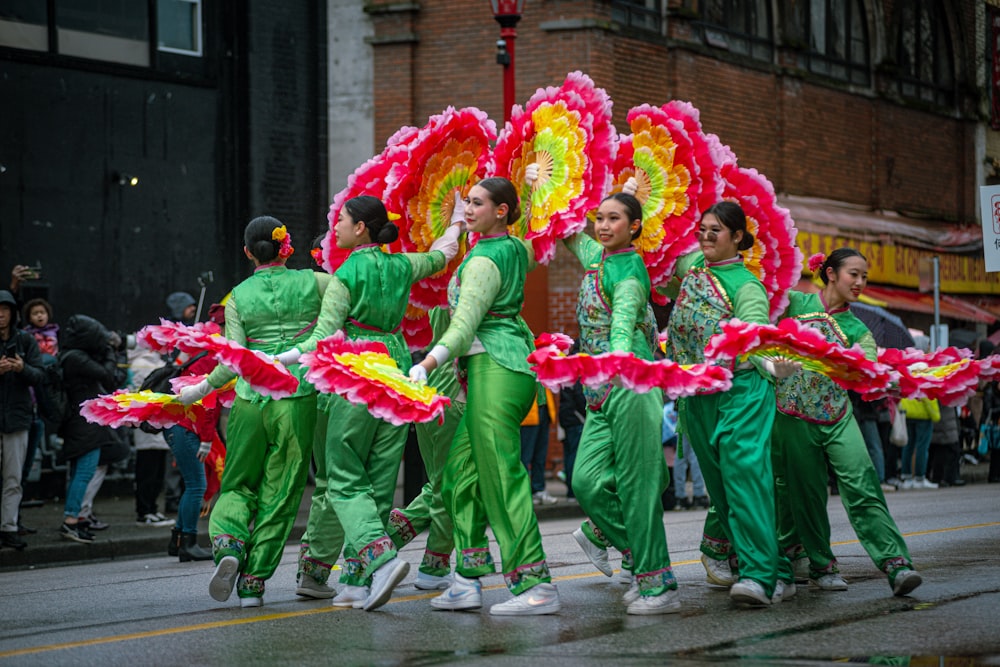 a group of people in green and red outfits
