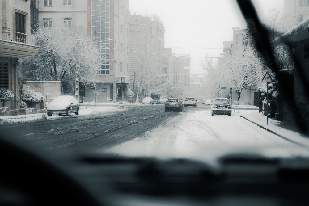 a car driving down a snow covered street