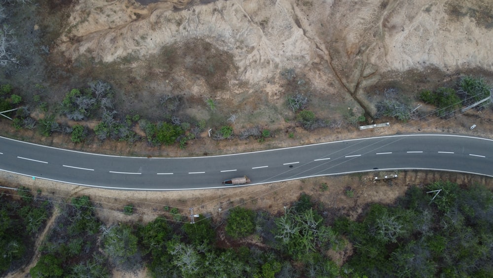 an aerial view of a road in the mountains
