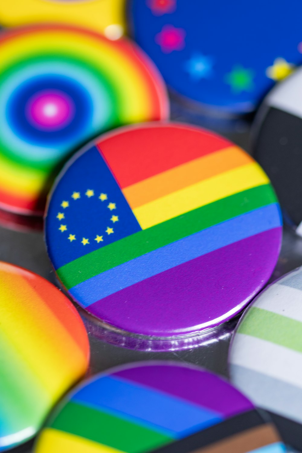 a close up of a rainbow colored button