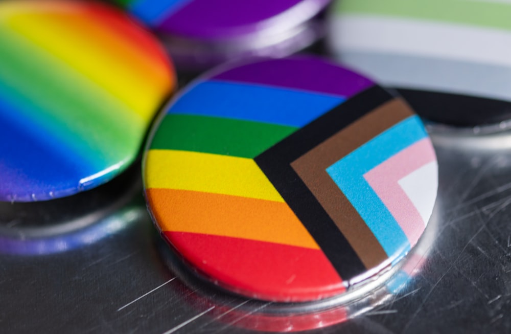 a close up of a rainbow colored button