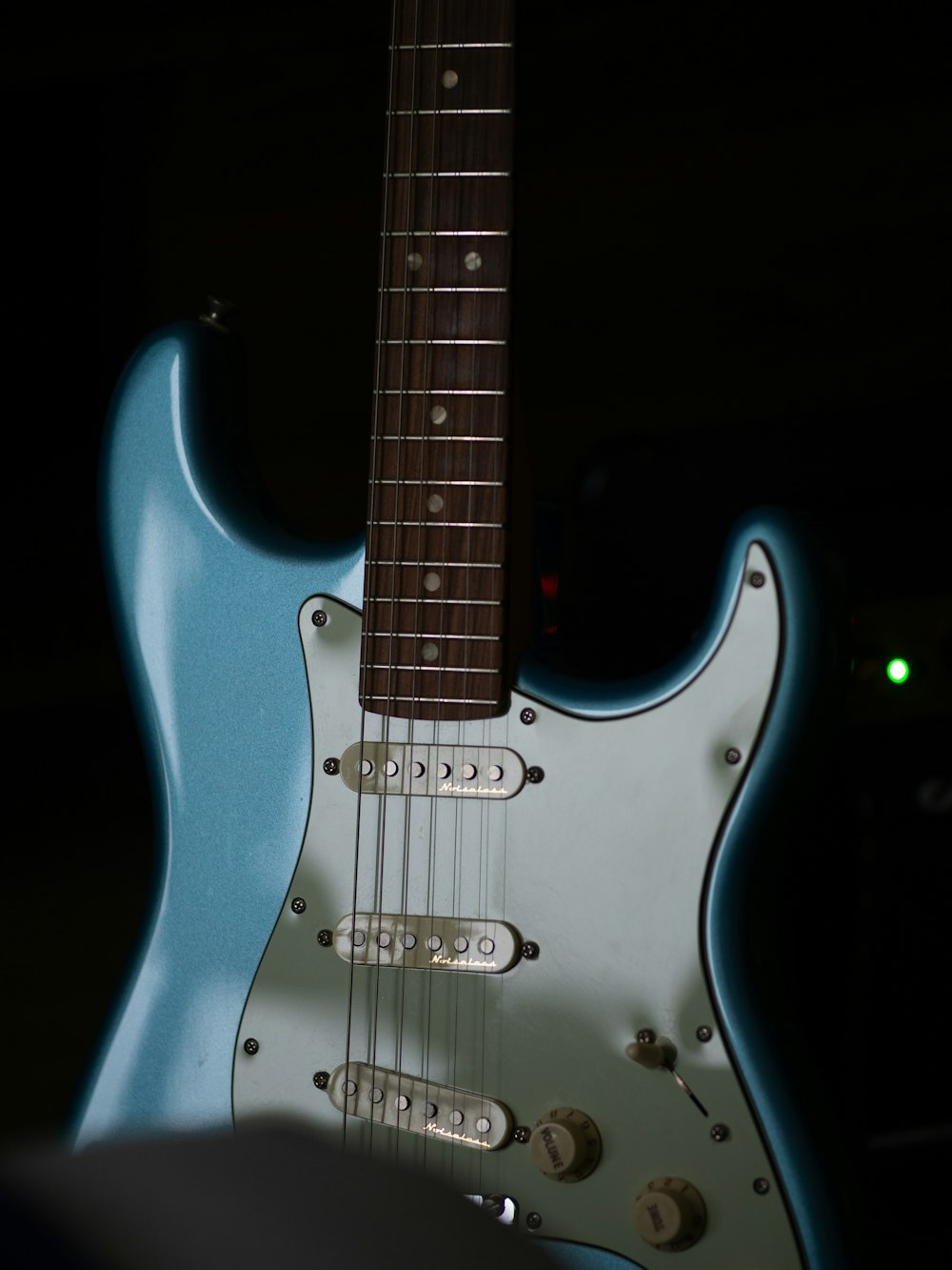 a blue electric guitar sitting on top of a table