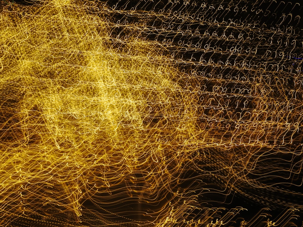 a blurry image of yellow lights on a black background