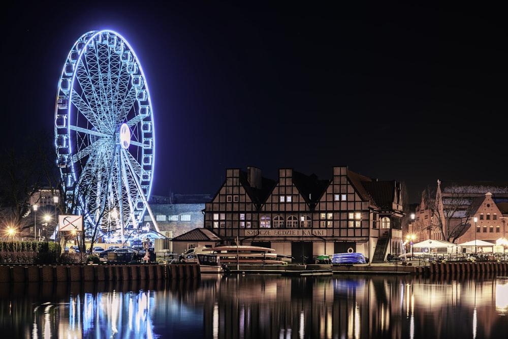 a ferris wheel is lit up at night