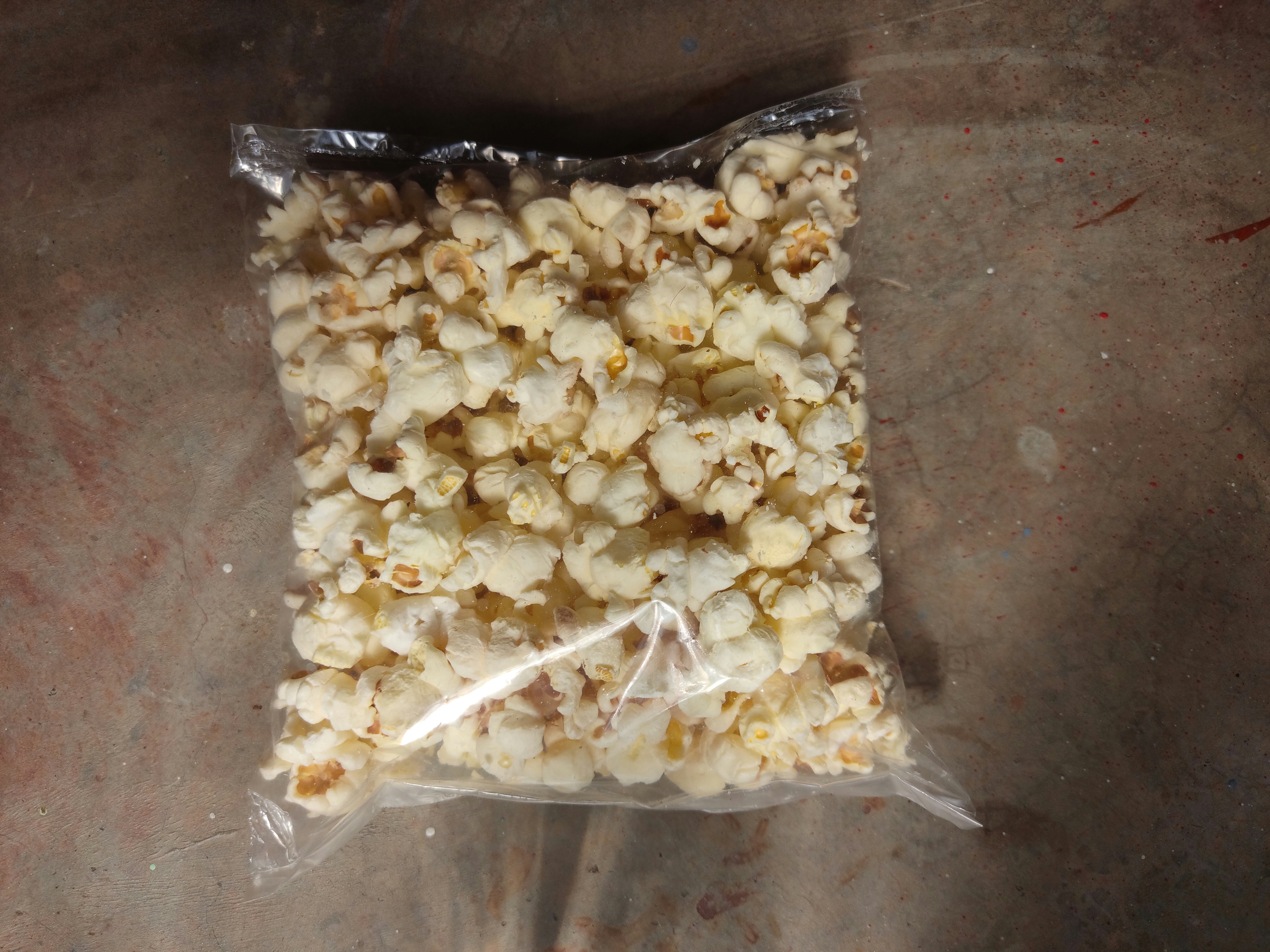 Lightly salted air-popped popcorn in a small snack bag