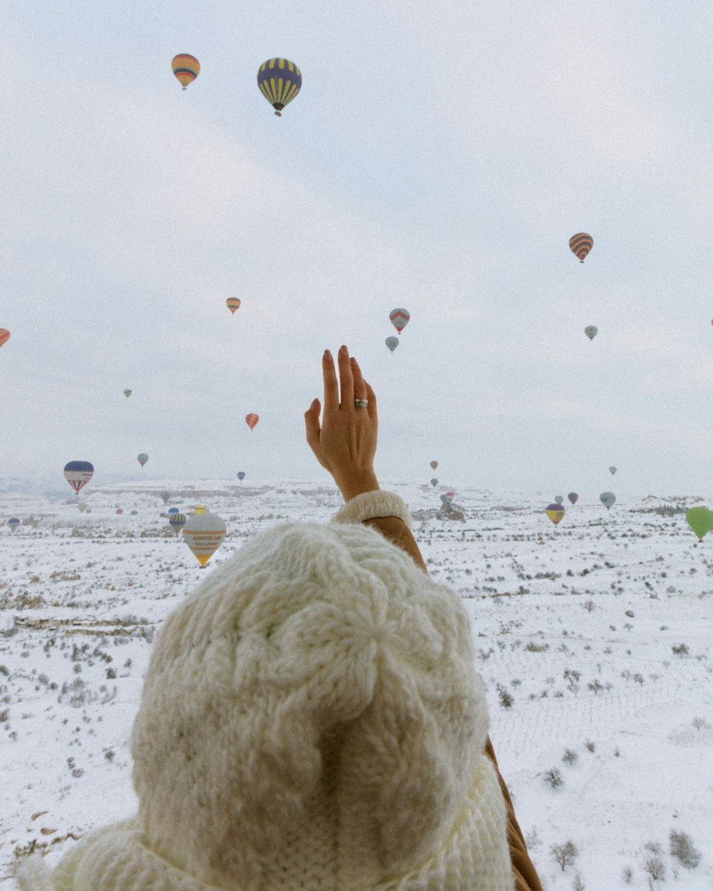 a person is looking at hot air balloons in the sky