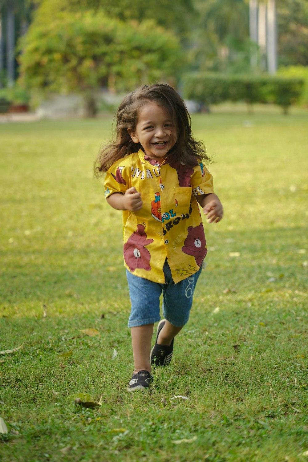 a little girl that is running in the grass