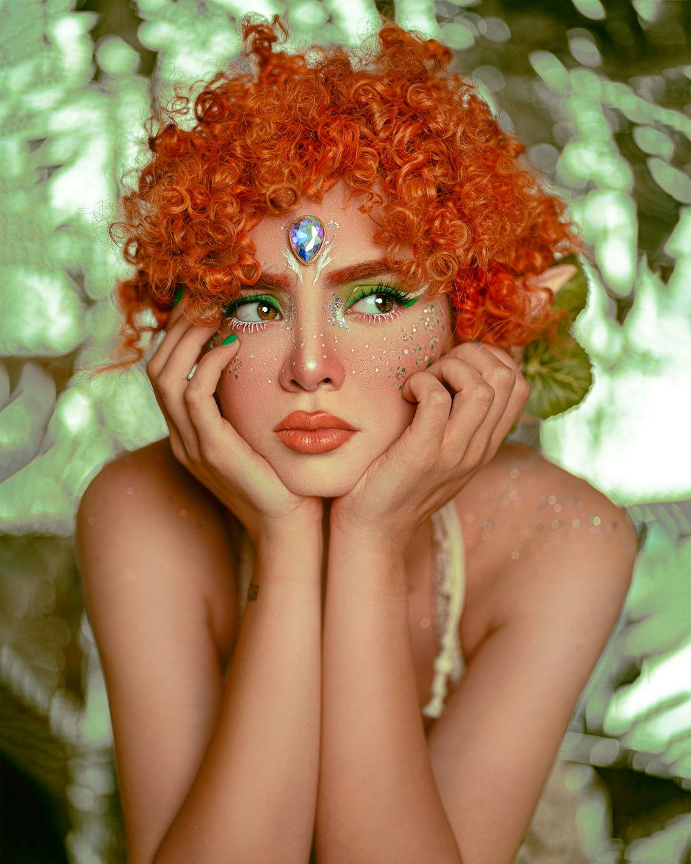 a woman with bright red hair and green eyes