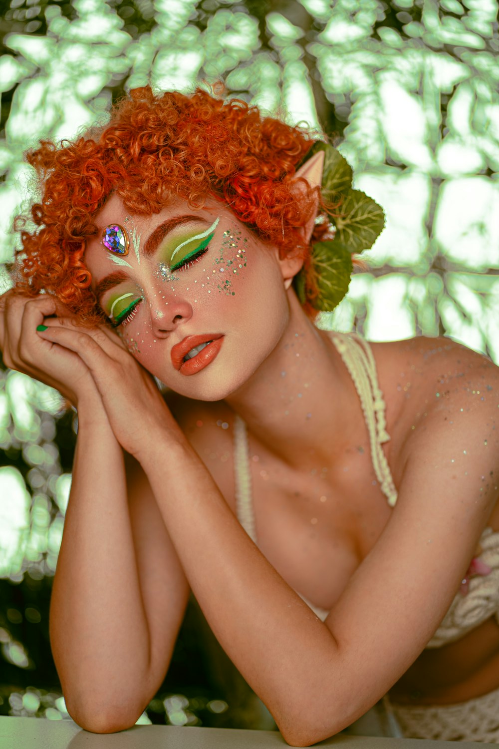 a woman with red hair and green makeup