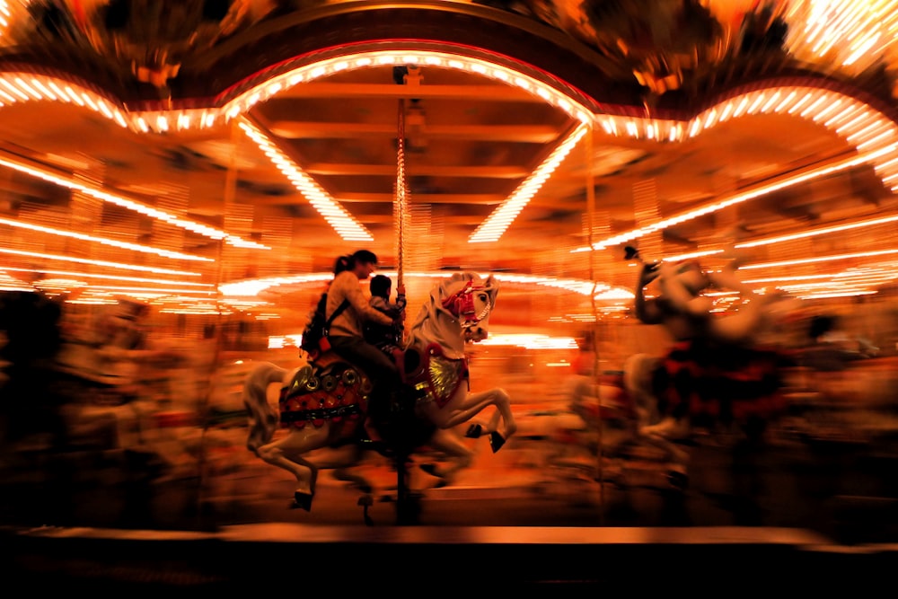 a blurry photo of a carousel with people riding on it