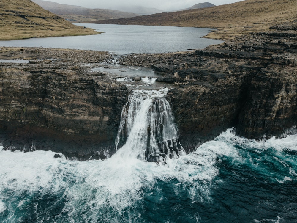 an aerial view of a waterfall and a body of water