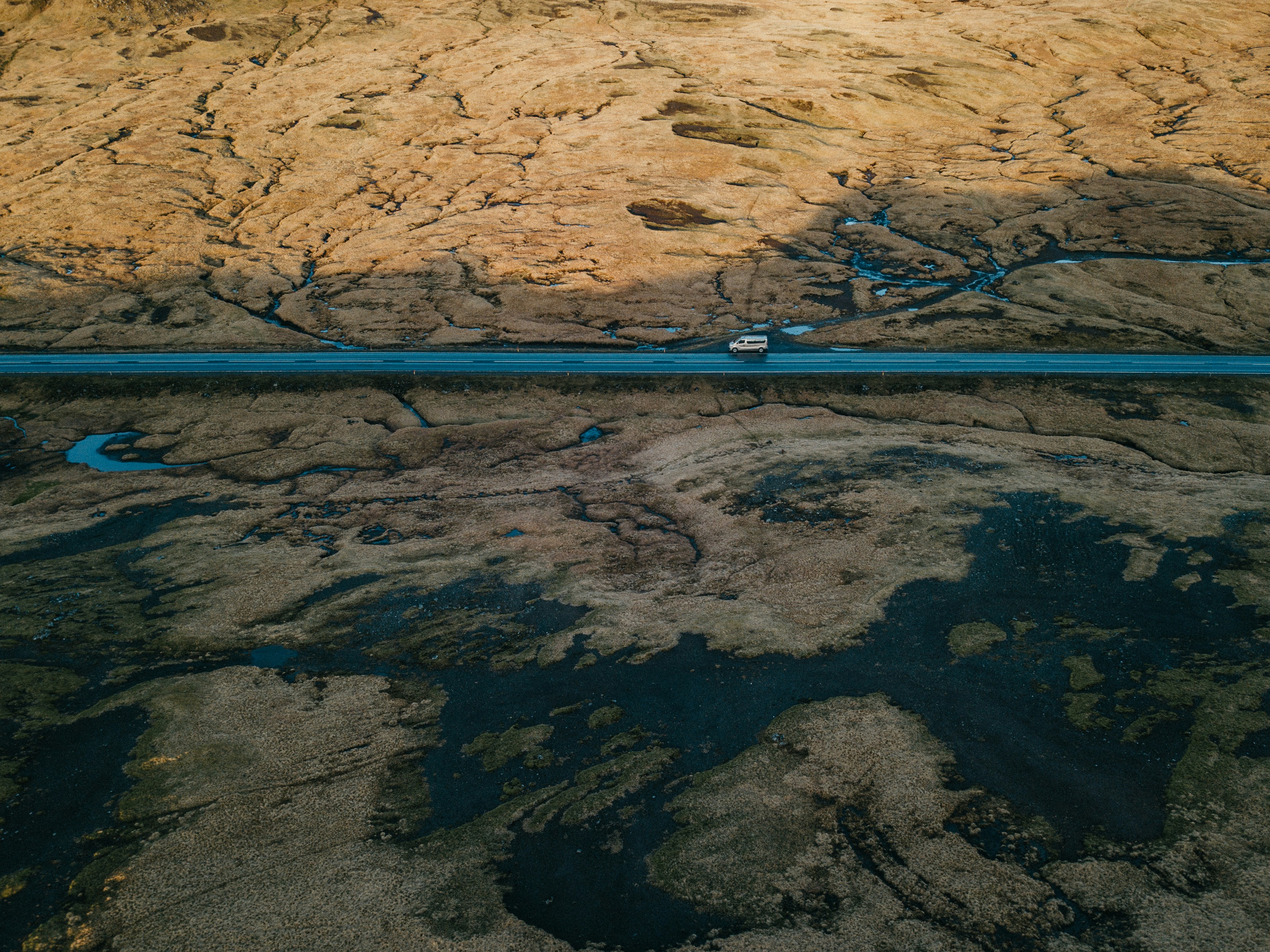 an aerial view of a highway in the mountains