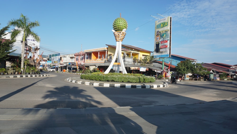 a street intersection with a palm tree in the middle