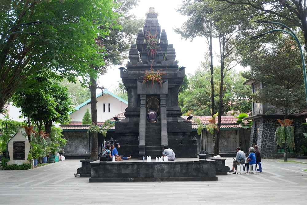 a group of people sitting around a fountain