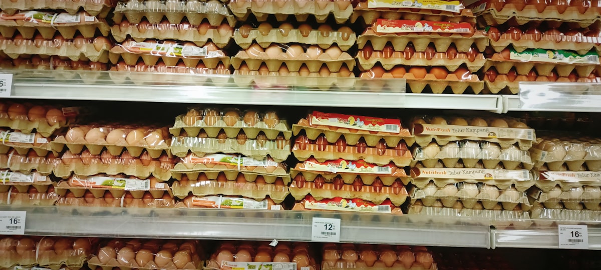 Rows of eggs on display at a grocery store supermarket
