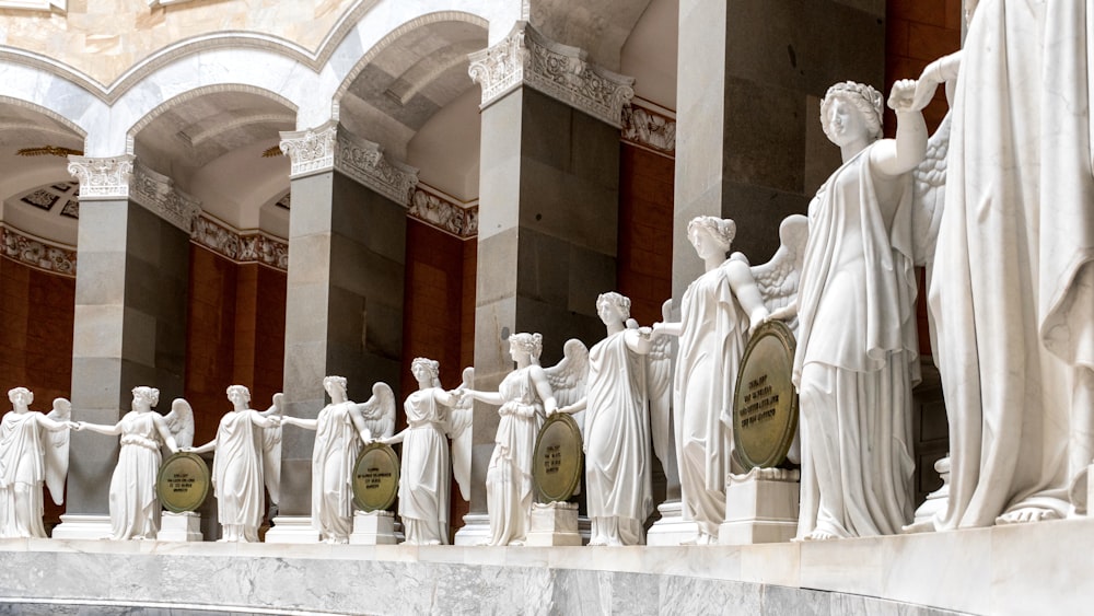 a group of white statues in a building