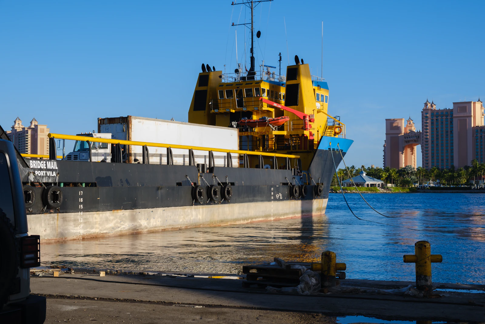 A yellow and black vessel docked at Potters Cay Dock in Nassau, The Bahamas