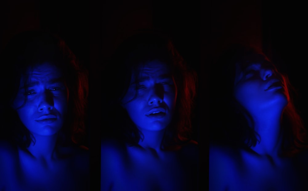 a woman in a dark room with blue light