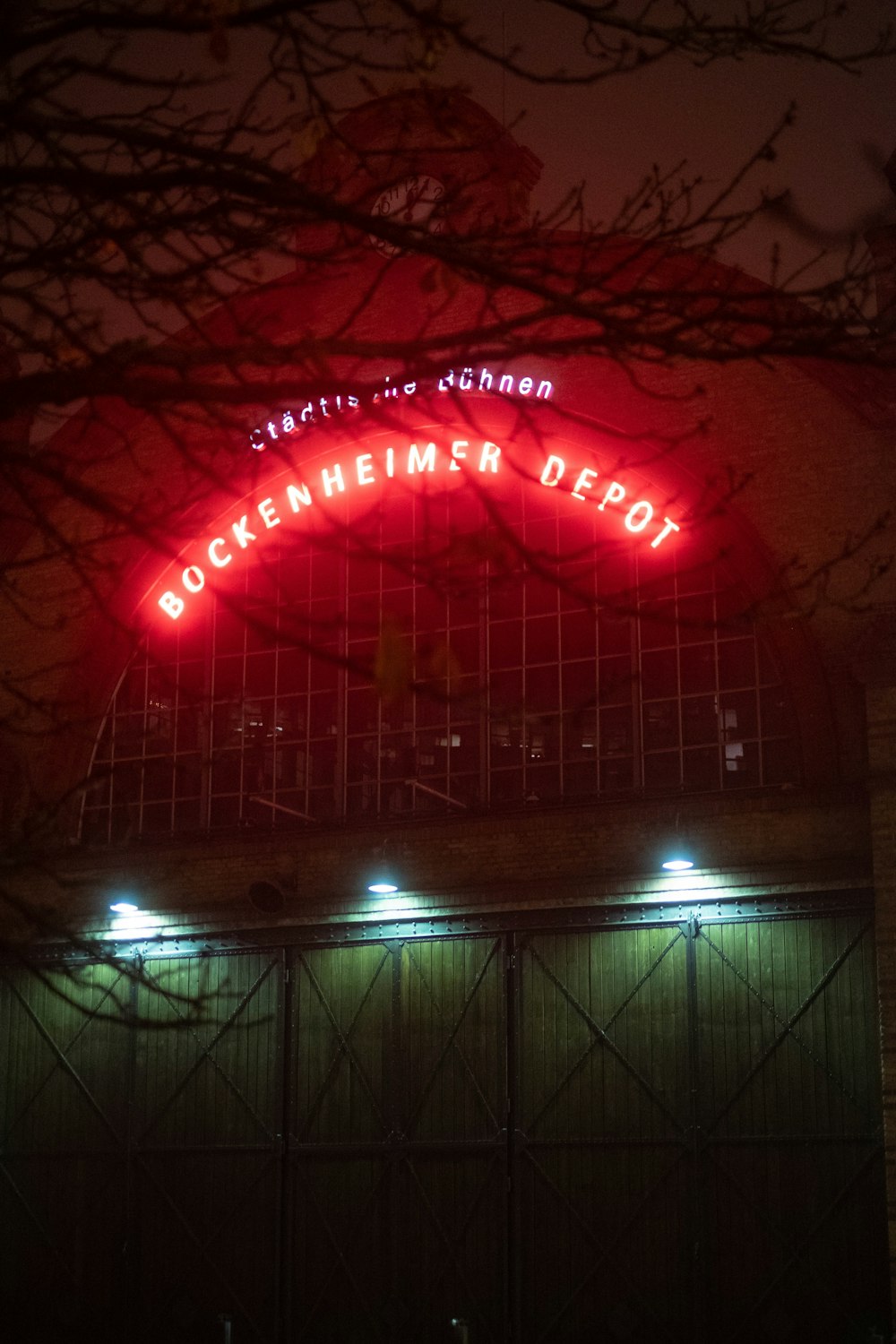 a red neon sign on the side of a building