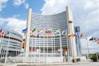 a large building with a lot of flags in front of it