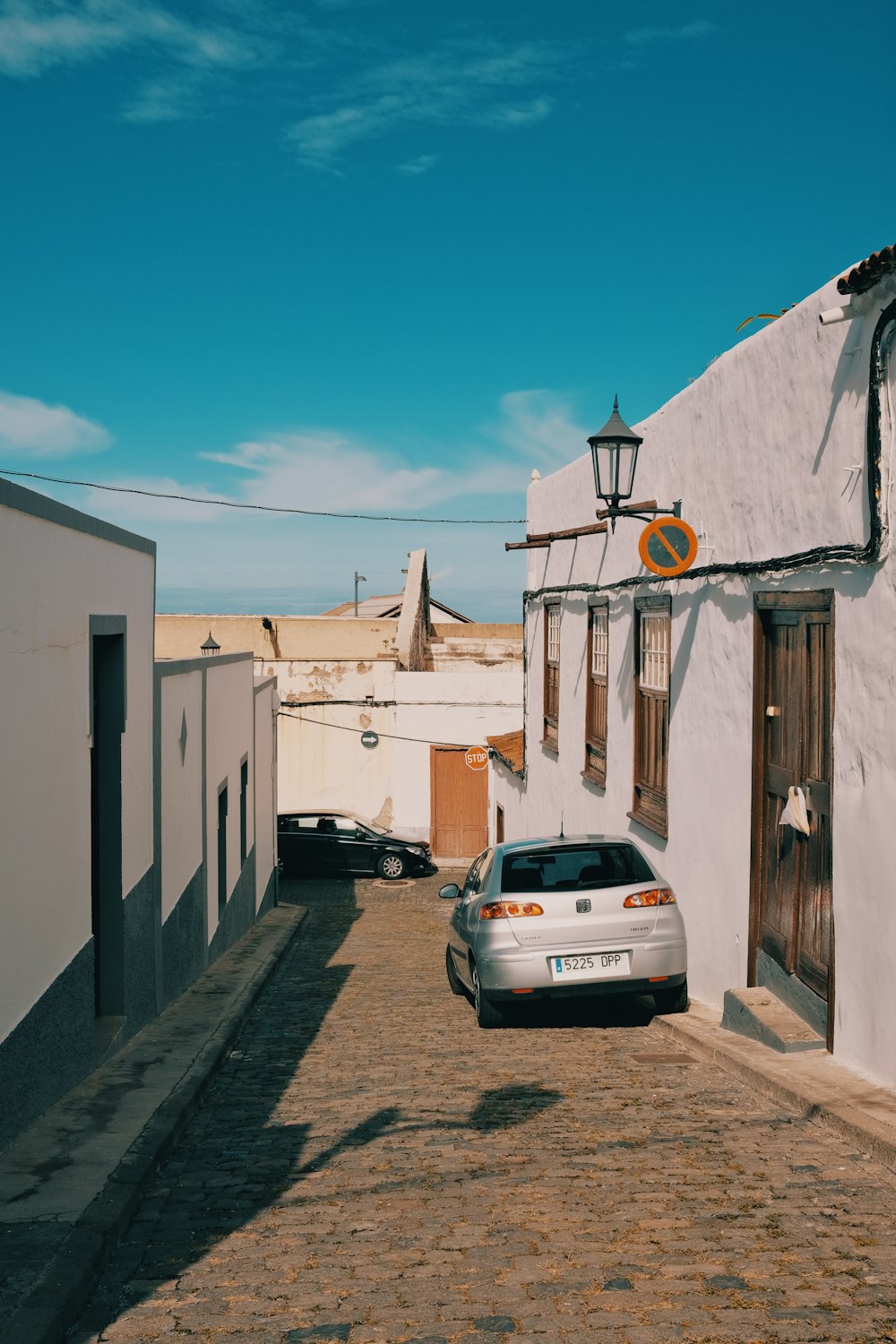 a car parked in front of a white building