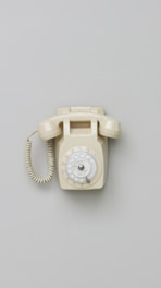 an old fashioned phone is on a gray surface
