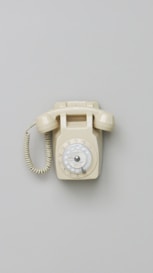 an old fashioned phone is on a gray surface