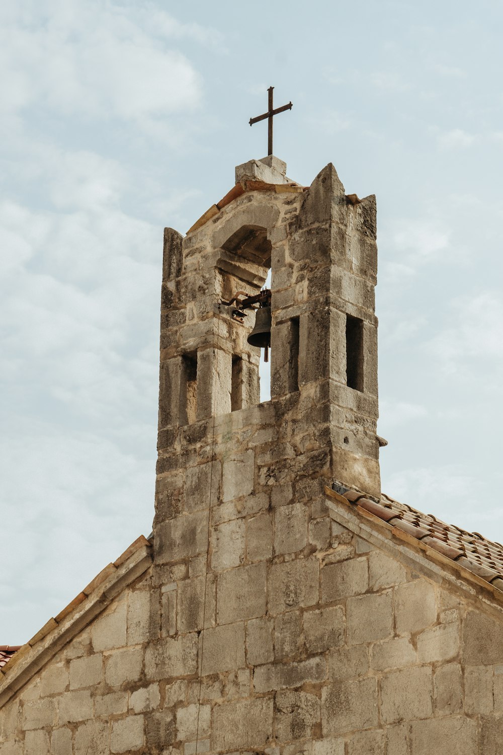 a church steeple with a cross on top