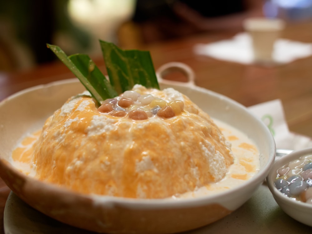 a bowl of food with a green leaf on top of it